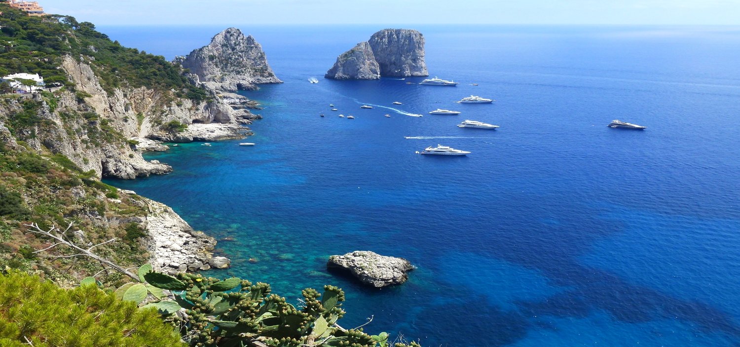 Capri yacht charters sail through bays and rocks in the Mediterranean